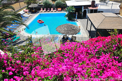 Image of romantic balcony with flowers and pool view