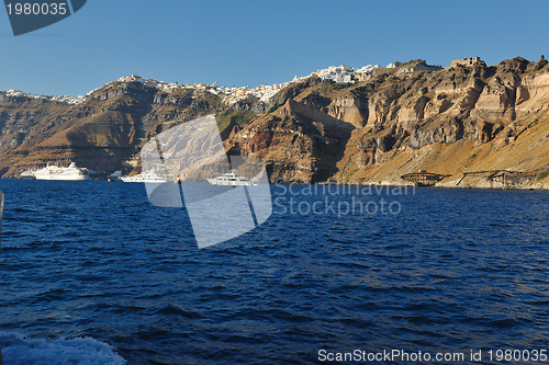 Image of santorini island coast with luxury yacht