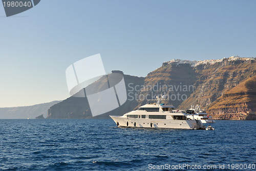 Image of santorini island coast with luxury yacht