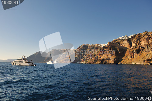 Image of santorini island coast with luxury yacht