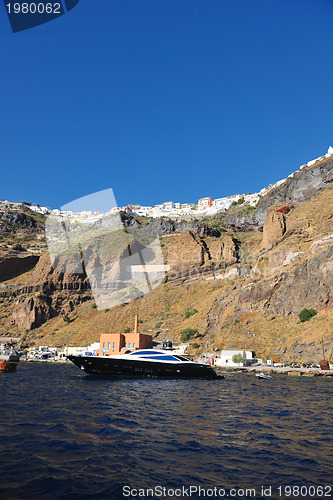 Image of santorini island coast with luxury yacht