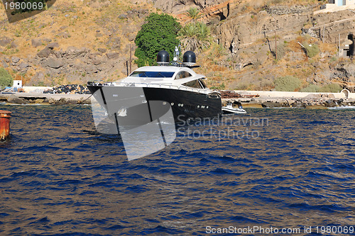 Image of santorini island coast with luxury yacht