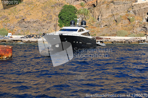 Image of santorini island coast with luxury yacht