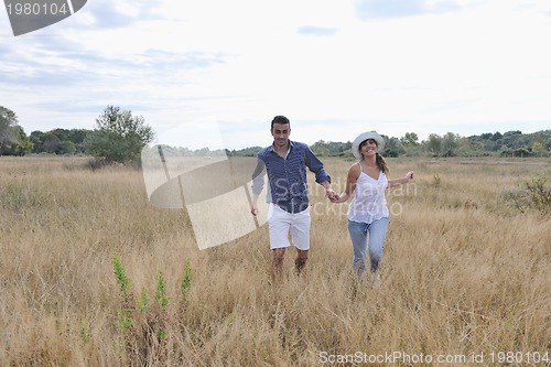 Image of happy young couple have romantic time outdoor