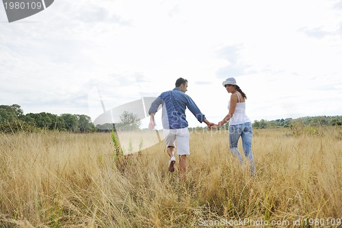 Image of happy young couple have romantic time outdoor