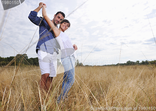 Image of happy young couple have romantic time outdoor