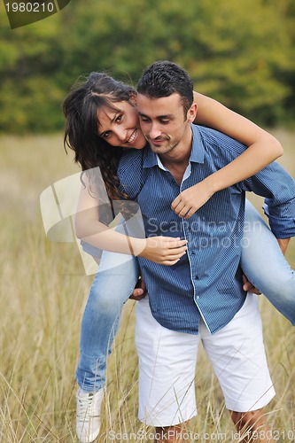 Image of happy young couple have romantic time outdoor