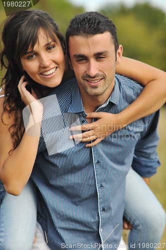 Image of happy young couple have romantic time outdoor