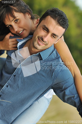 Image of happy young couple have romantic time outdoor