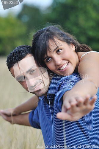 Image of happy young couple have romantic time outdoor
