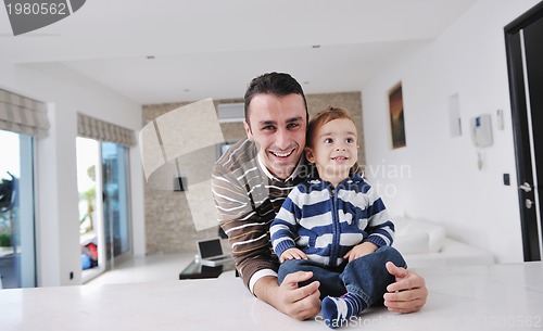 Image of happy father and son together at home