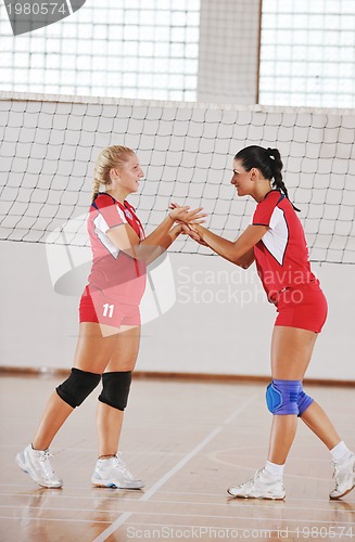 Image of girls playing volleyball indoor game