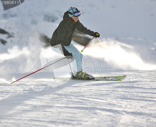 Image of woman skiing on fresh snow at winter season 