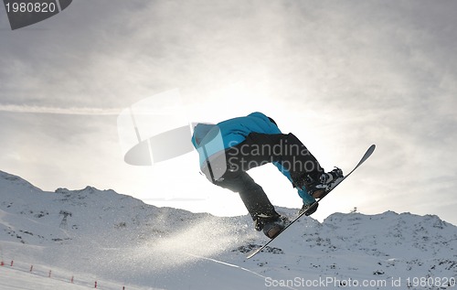 Image of snowboarder extreme jump