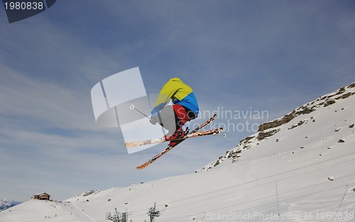 Image of happy young man have fun at winter on mountain peak