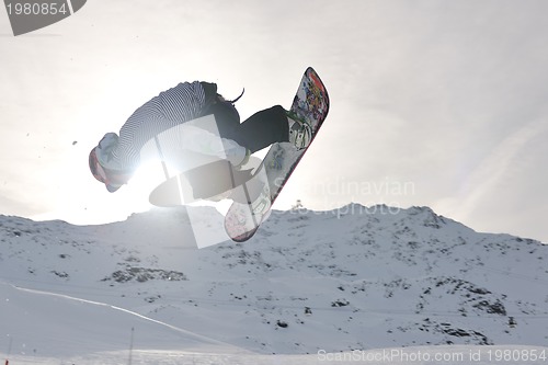 Image of snowboarder extreme jump