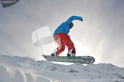 Image of happy young man have fun at winter on mountain peak