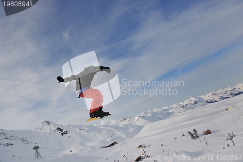 Image of happy young man have fun at winter on mountain peak