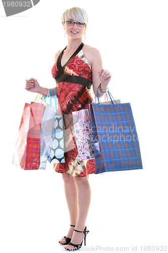 Image of happy young adult women  shopping with colored bags