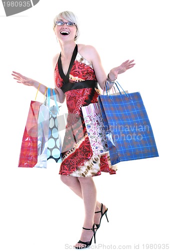 Image of happy young adult women  shopping with colored bags