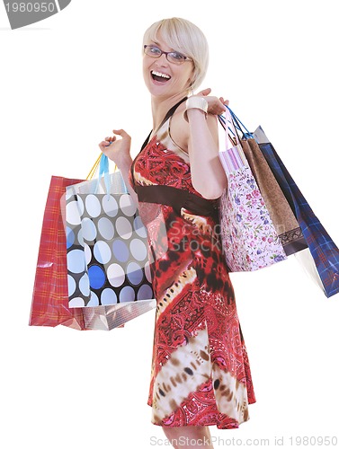 Image of happy young adult women  shopping with colored bags