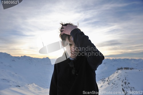 Image of happy young man have fun at winter on mountain peak