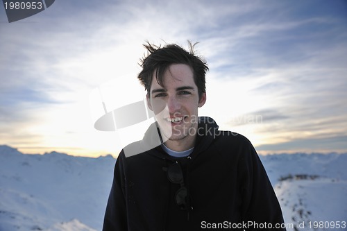 Image of happy young man have fun at winter on mountain peak