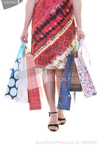 Image of happy young adult women  shopping with colored bags