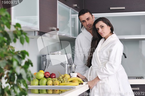 Image of Young love couple taking fresh morning cup of coffee