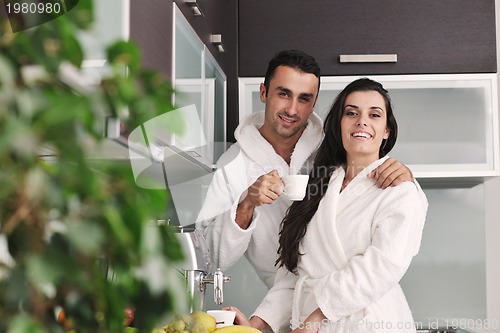 Image of Young love couple taking fresh morning cup of coffee