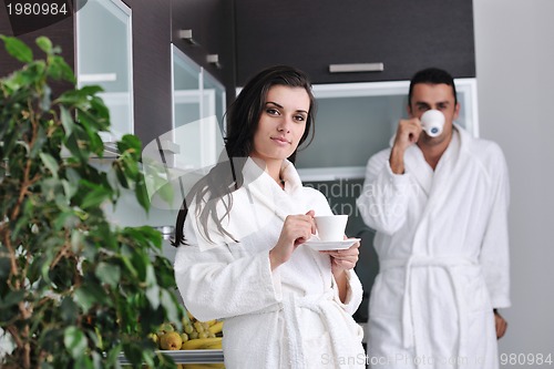 Image of Young love couple taking fresh morning cup of coffee