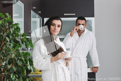 Image of Young love couple taking fresh morning cup of coffee