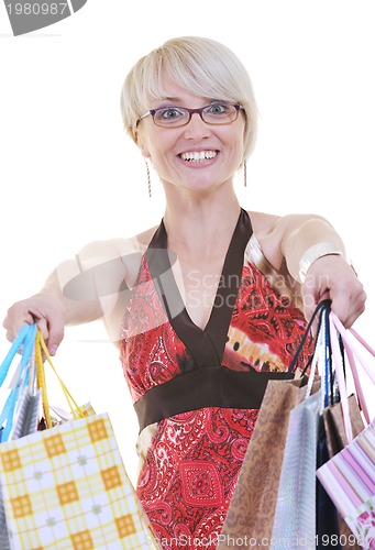 Image of happy young adult women  shopping with colored bags