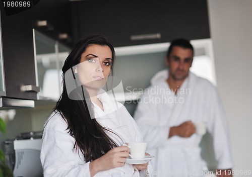 Image of Young love couple taking fresh morning cup of coffee