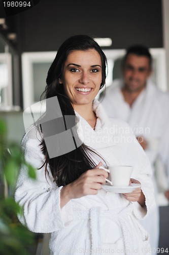 Image of Young love couple taking fresh morning cup of coffee