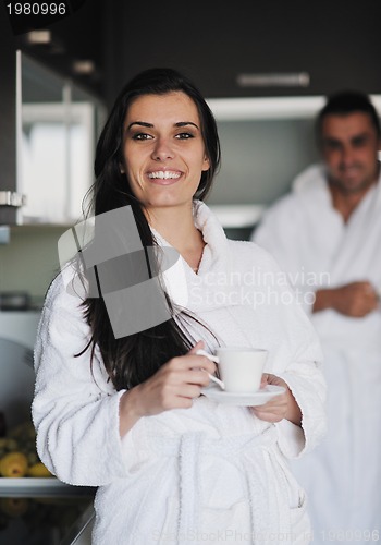 Image of Young love couple taking fresh morning cup of coffee