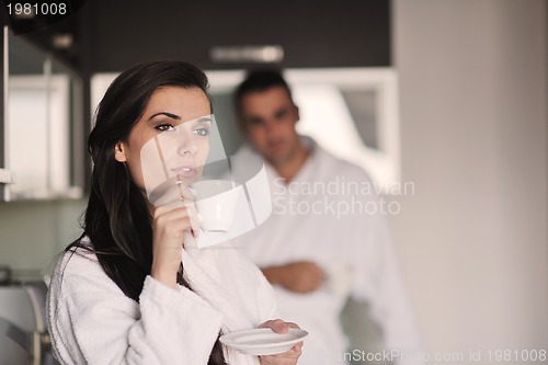 Image of Young love couple taking fresh morning cup of coffee