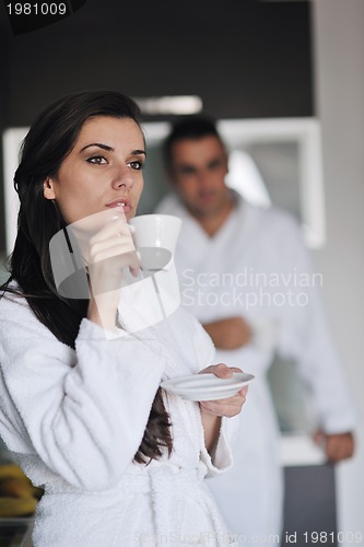 Image of Young love couple taking fresh morning cup of coffee