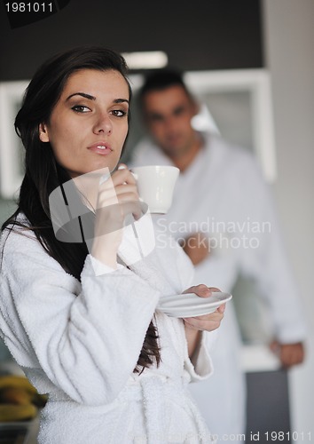 Image of Young love couple taking fresh morning cup of coffee