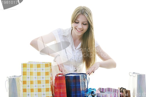 Image of happy young adult women  shopping with colored bags