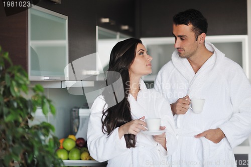 Image of Young love couple taking fresh morning cup of coffee