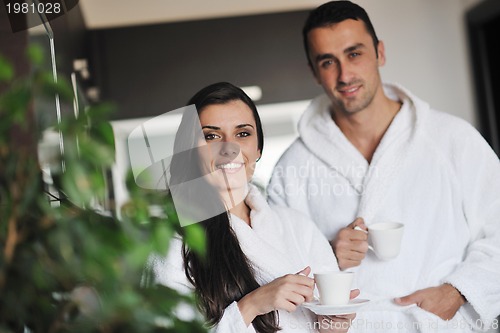 Image of Young love couple taking fresh morning cup of coffee