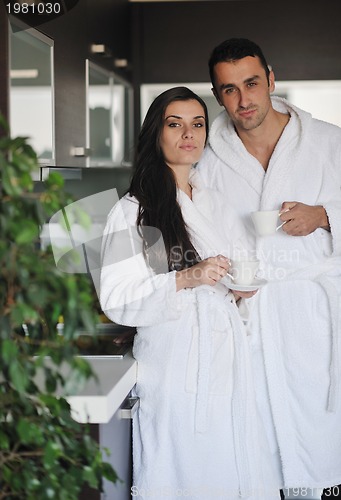 Image of Young love couple taking fresh morning cup of coffee