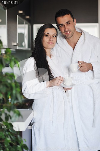 Image of Young love couple taking fresh morning cup of coffee