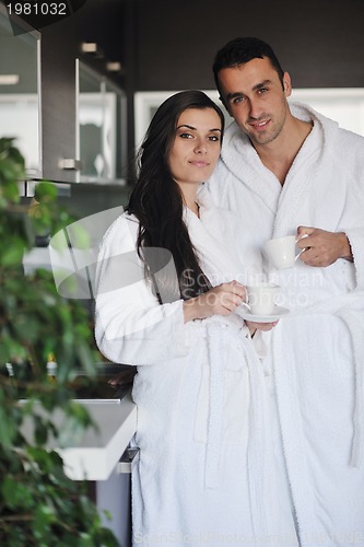 Image of Young love couple taking fresh morning cup of coffee