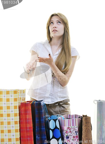 Image of happy young adult women  shopping with colored bags