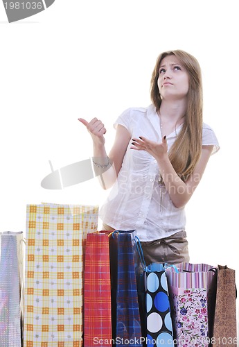 Image of happy young adult women  shopping with colored bags