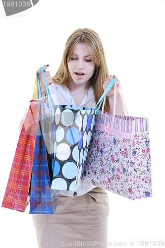 Image of happy young adult women  shopping with colored bags