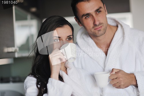 Image of Young love couple taking fresh morning cup of coffee