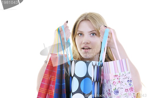 Image of happy young adult women  shopping with colored bags